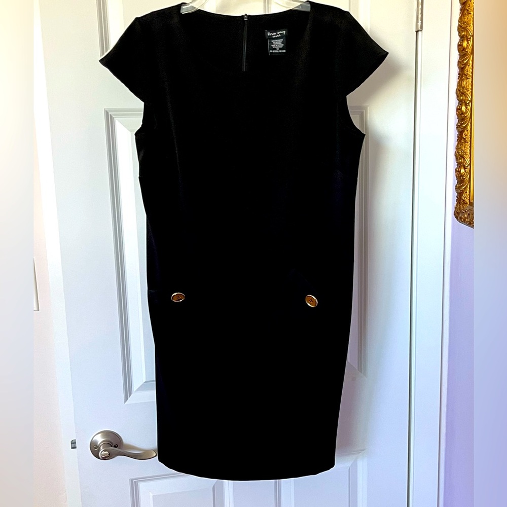 Cute black Dress. Above knee. Never worn. Size 12. Wash and wear.